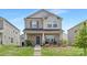 Beautiful two-story home with a brick facade, landscaped front yard, and welcoming entrance at 363 Cedar Knoll Cir, Pineville, NC 28134
