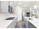 Modern kitchen with stainless steel appliances, gray cabinetry, and a large island with white countertops at 363 Cedar Knoll Cir, Pineville, NC 28134