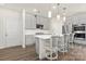 Modern kitchen with stainless steel appliances, an island with seating, and pendant lights at 363 Cedar Knoll Cir, Pineville, NC 28134
