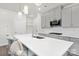Stylish kitchen featuring a large island with white countertops, gray cabinetry, and modern lighting fixtures at 363 Cedar Knoll Cir, Pineville, NC 28134