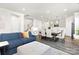 Open floor plan with stylish blue sofa, ottoman, dining table, and modern kitchen at 363 Cedar Knoll Cir, Pineville, NC 28134