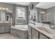 Bright bathroom featuring a soaking tub, double sinks with framed mirrors, and luxury countertops at 4071 Thames Cir, Fort Mill, SC 29715