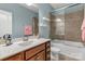 Bright bathroom with a single sink, a mirror, and a shower-tub, creating a functional space for personal care at 4071 Thames Cir, Fort Mill, SC 29715