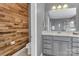 Updated bathroom featuring shiplap accent wall, grey cabinets, and a marble countertop with a stylish mirror at 4071 Thames Cir, Fort Mill, SC 29715