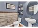 Charming powder room with stylish wood-look tile accent wall and modern fixtures at 4071 Thames Cir, Fort Mill, SC 29715