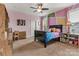 This bedroom has colorful walls, a ceiling fan, a window, a bed, and a desk providing plenty of space for sleep and study at 4071 Thames Cir, Fort Mill, SC 29715