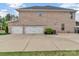 Three-car garage with automatic doors and ample parking space, set in a brick home at 4071 Thames Cir, Fort Mill, SC 29715