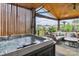 Enjoy the backyard views from this covered patio and seating area with a hot tub at 4071 Thames Cir, Fort Mill, SC 29715