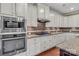 This kitchen features white cabinets and granite countertops, with stainless steel appliances at 4071 Thames Cir, Fort Mill, SC 29715
