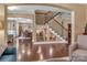 Spacious living area with hardwood floors, open staircase, and access to the dining area at 4071 Thames Cir, Fort Mill, SC 29715