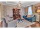 Inviting living room featuring neutral walls, hardwood floors, and an elegant display cabinet at 4071 Thames Cir, Fort Mill, SC 29715