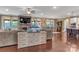 Open-concept living space with a stone fireplace, media center, and views to the kitchen and dining area at 4071 Thames Cir, Fort Mill, SC 29715