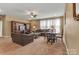 Spacious living room features a ceiling fan, lots of seating, and a dining table, making it an ideal space for relaxation at 4071 Thames Cir, Fort Mill, SC 29715