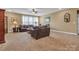 Spacious living room with neutral carpet, a ceiling fan, and multiple seating areas at 4071 Thames Cir, Fort Mill, SC 29715