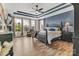 Stunning main bedroom featuring tray ceilings, hardwood floors, and large windows for abundant natural light at 4071 Thames Cir, Fort Mill, SC 29715