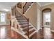 Staircase with wood and iron detailing, showcasing a wine cellar below the stairs at 4071 Thames Cir, Fort Mill, SC 29715