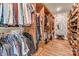 Spacious walk-in closet with built-in wooden shelves and ample storage space for clothes and shoes at 4071 Thames Cir, Fort Mill, SC 29715