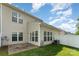 Backyard featuring a patio, green grass, and white vinyl fence at 4208 Carl Parmer Dr, Harrisburg, NC 28075