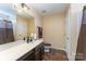 Bathroom with white countertop and brown cabinets and fixtures at 4208 Carl Parmer Dr, Harrisburg, NC 28075