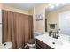 Bathroom with shower, dark cabinets, and modern fixtures at 4208 Carl Parmer Dr, Harrisburg, NC 28075