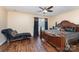 Main bedroom with hardwood floors, ceiling fan, and decorative chaise lounge at 4208 Carl Parmer Dr, Harrisburg, NC 28075