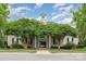 Inviting neighborhood clubhouse entrance with beige siding, green trees, and a walkway at 4208 Carl Parmer Dr, Harrisburg, NC 28075