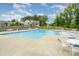 Large community pool with tables, chairs, and a view of nearby townhomes at 4208 Carl Parmer Dr, Harrisburg, NC 28075