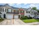 Charming townhouse with brick and siding exterior, complemented by a well-maintained lawn and attached garages at 4208 Carl Parmer Dr, Harrisburg, NC 28075