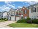 Charming townhouse with brick and siding exterior, complemented by a well-maintained lawn and attached garages at 4208 Carl Parmer Dr, Harrisburg, NC 28075