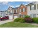 Charming brick townhome with a one car garage, well manicured lawn, and sunny skies at 4208 Carl Parmer Dr, Harrisburg, NC 28075