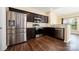 Modern kitchen featuring stainless steel appliances, dark cabinetry, and an open layout at 4208 Carl Parmer Dr, Harrisburg, NC 28075