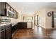 Stylish kitchen featuring stainless steel appliances, dark cabinetry, and an open layout at 4208 Carl Parmer Dr, Harrisburg, NC 28075