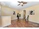 Open living room with hardwood floors, ceiling fan, and natural light at 4208 Carl Parmer Dr, Harrisburg, NC 28075