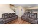 Cozy living room features hardwood floors and comfortable leather furniture at 4208 Carl Parmer Dr, Harrisburg, NC 28075