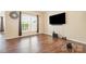 A bright living room with wood floors, neutral walls, and lots of natural light at 4208 Carl Parmer Dr, Harrisburg, NC 28075