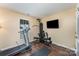 Workout room with treadmill, multi-station weight machine, and wall-mounted TV at 4208 Carl Parmer Dr, Harrisburg, NC 28075
