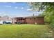 Brick home with a covered back porch and a spacious lawn at 4623 Drifter Dr # 30, Charlotte, NC 28227