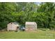 Lush backyard with a shed and greenhouse, ideal for gardening and outdoor activities at 4623 Drifter Dr # 30, Charlotte, NC 28227