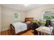 Well-lit bedroom with a desk area, hardwood floors, and a view of the outdoors at 4623 Drifter Dr # 30, Charlotte, NC 28227