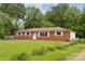 Traditional brick home with a well-manicured front yard and mature trees at 4623 Drifter Dr # 30, Charlotte, NC 28227