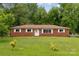 Ranch-style brick home with a well-manicured front yard and mature trees at 4623 Drifter Dr # 30, Charlotte, NC 28227