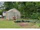 Backyard greenhouse with various plants and gardening supplies at 4623 Drifter Dr # 30, Charlotte, NC 28227