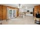 Spacious kitchen with wood-paneled walls, white cabinets, and access to an outdoor deck at 4623 Drifter Dr # 30, Charlotte, NC 28227