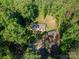 Overhead shot of a home with lush greenery surrounding it and a detached shed adding extra space to the property at 4920 Morrison Houser Trl # 2, Lincolnton, NC 28092