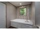 Bright bathroom features a soaking tub with jets, a window, and wood-look flooring at 4920 Morrison Houser Trl # 2, Lincolnton, NC 28092