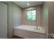 Bright bathroom features a soaking tub with jets, a window, and wood-look flooring at 4920 Morrison Houser Trl # 2, Lincolnton, NC 28092