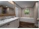 Bathroom with double vanity sinks with white marble counters and soaking tub and window at 4920 Morrison Houser Trl # 2, Lincolnton, NC 28092
