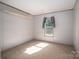 Comfortable bedroom with neutral walls, carpet, and a large window for natural light at 4920 Morrison Houser Trl # 2, Lincolnton, NC 28092