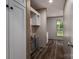 Clean hallway featuring wood floors, storage with shelves, leading to a bathroom with lots of sunlight at 4920 Morrison Houser Trl # 2, Lincolnton, NC 28092
