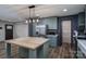 Kitchen features island and stainless steel appliances, with modern light fixture at 4920 Morrison Houser Trl # 2, Lincolnton, NC 28092